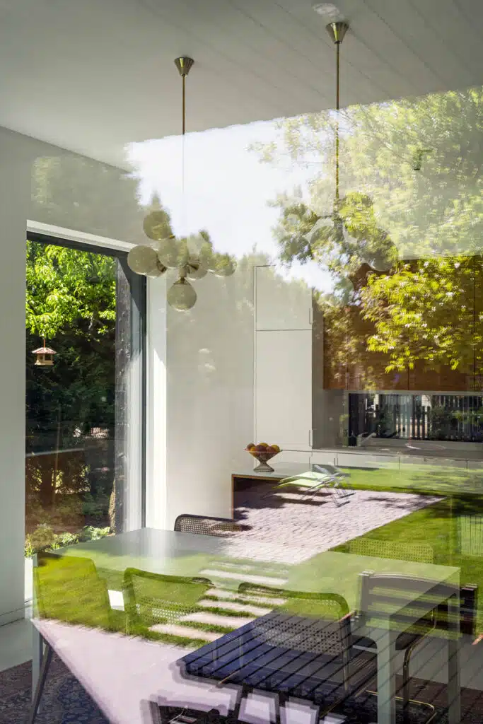 A dining room with a table and chairs.