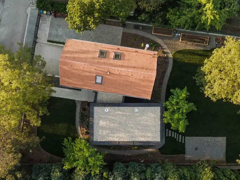 An aerial view of a house surrounded by trees.