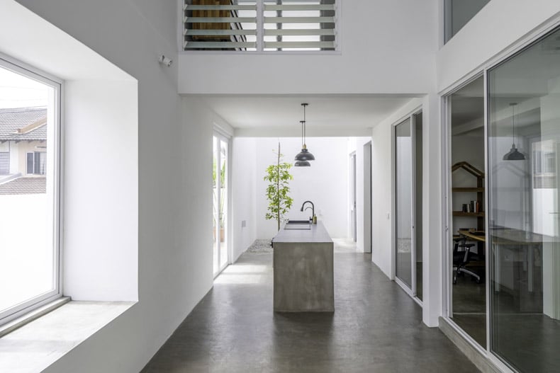 Embark on a voyage through Insight House, a magnificent space featuring white walls and a wooden floor.