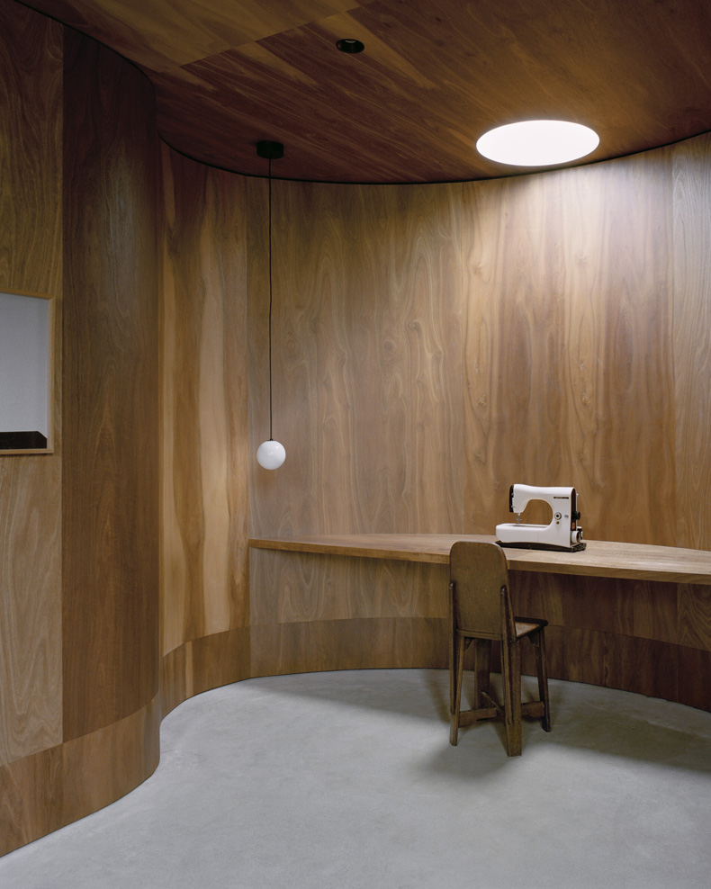 A Mary Street House with wooden walls and a desk.