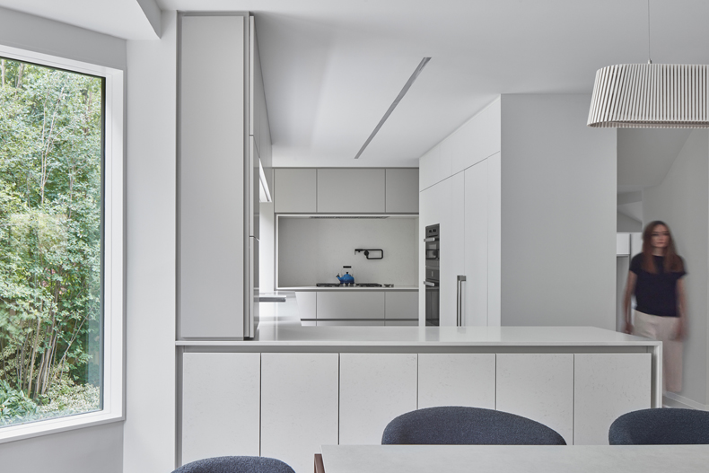 Murray Brown House By Creative Union Network showcases a white kitchen with a large window.
