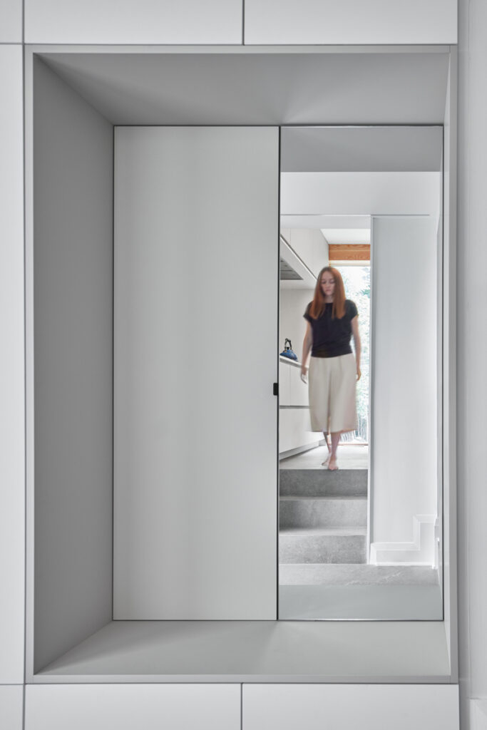 A woman in Murray Brown House standing in front of a mirror.