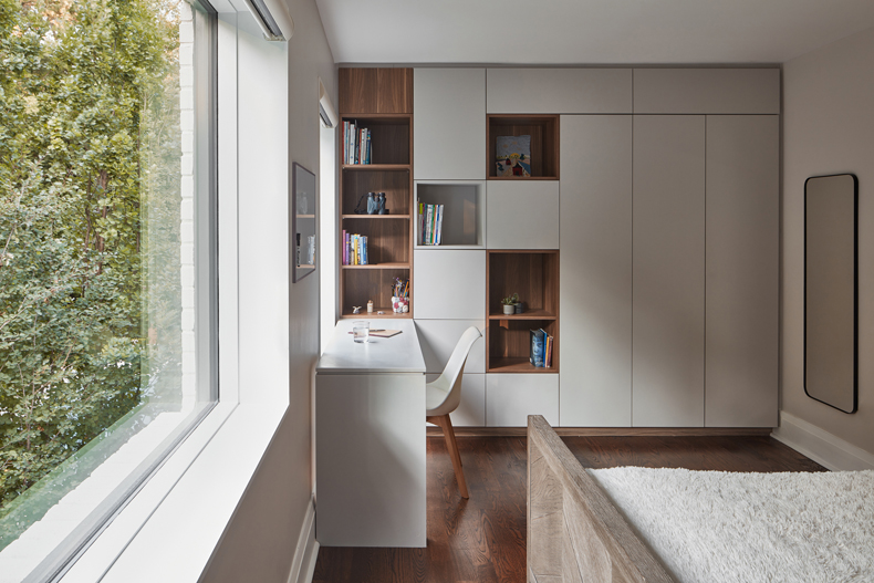 A bedroom with bookshelves in the Murray Brown House.