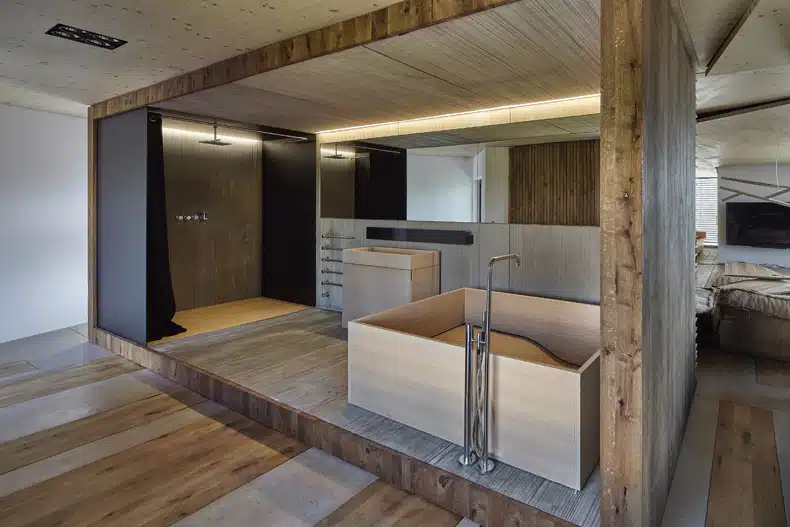 A bathroom with wooden walls and a wooden bathtub.