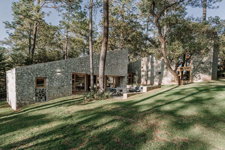 Petraia House by Argdl is a stone house surrounded by woods.
