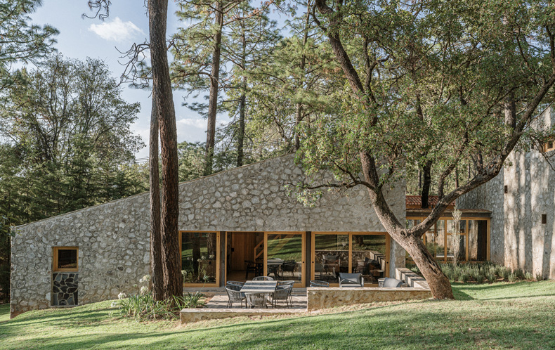 Petraia House, situated in a wooded area, is crafted from stone.