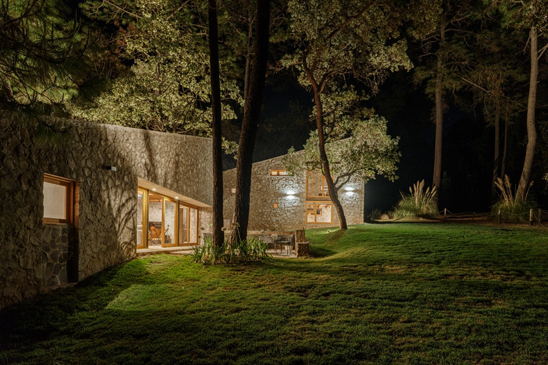 Petraia House, nestled among the trees, radiates enchantment under the veil of night.