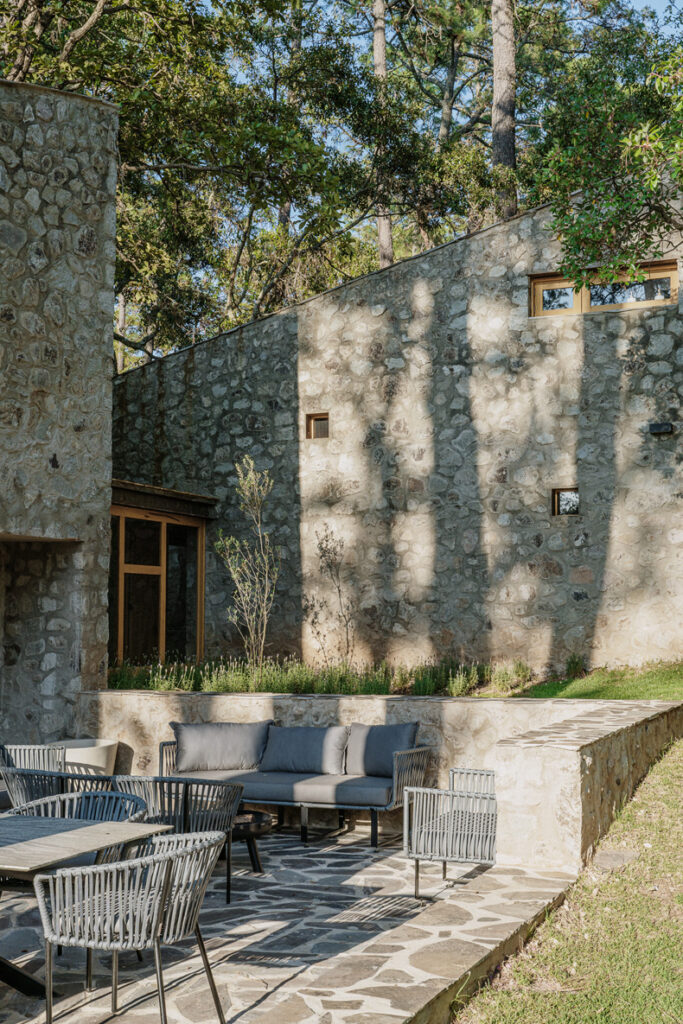 A stone patio with furniture at Petraia House By Argdl.