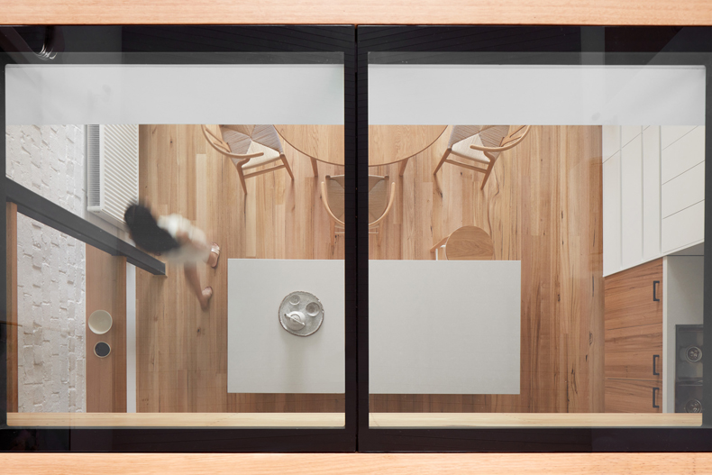 A person is standing in front of a glass door, inspired by Through The Looking Glass By Ben Callery Architects.
