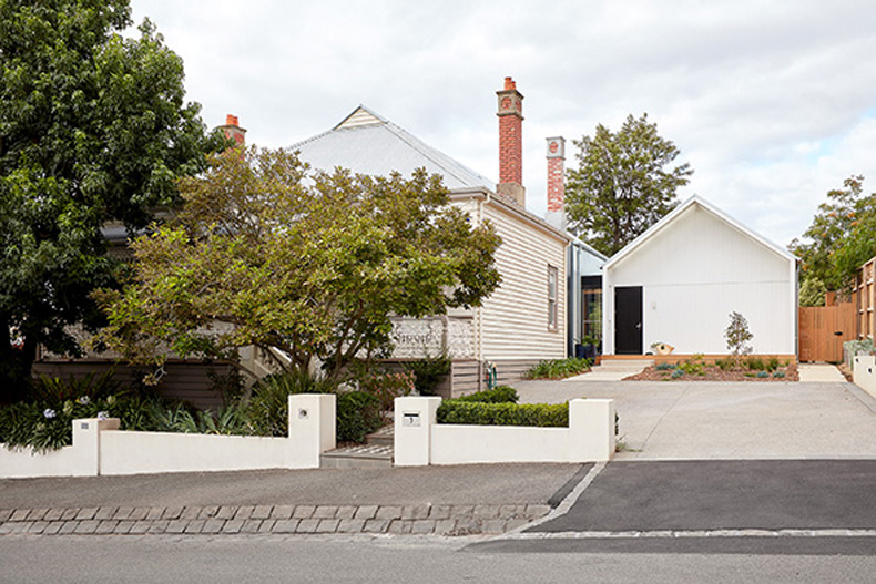 A white house with a driveway and trees for auto draft.