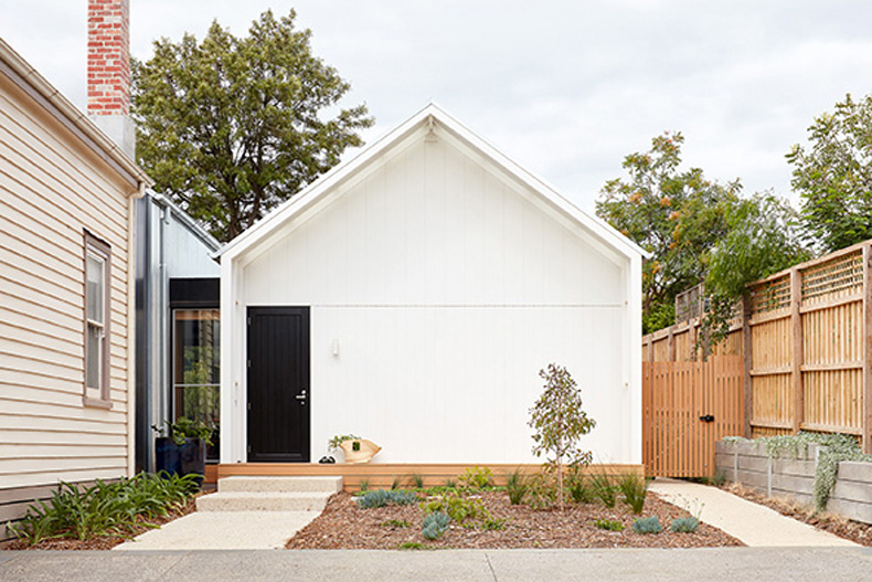 A small house with a black door.