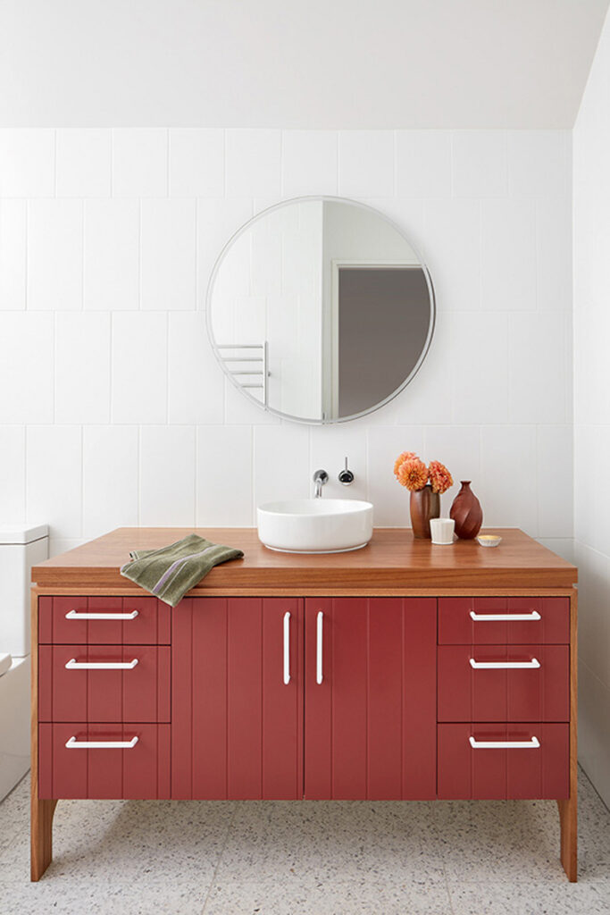 Twin Peaks House By Mihaly Slocombe featuring a white bathroom with a red vanity.