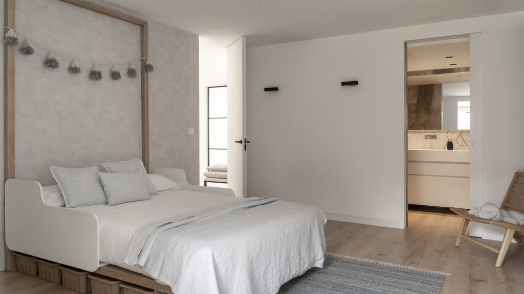 Citric House by Susanna Cots Interior Design featuring a bedroom with a bed and wooden floor.