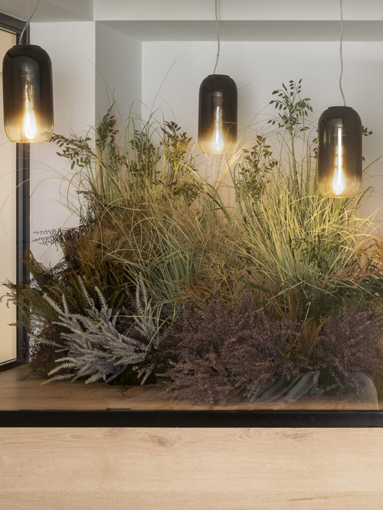 A table adorned with an assortment of plants and designed by Susanna Cots Interior Design.