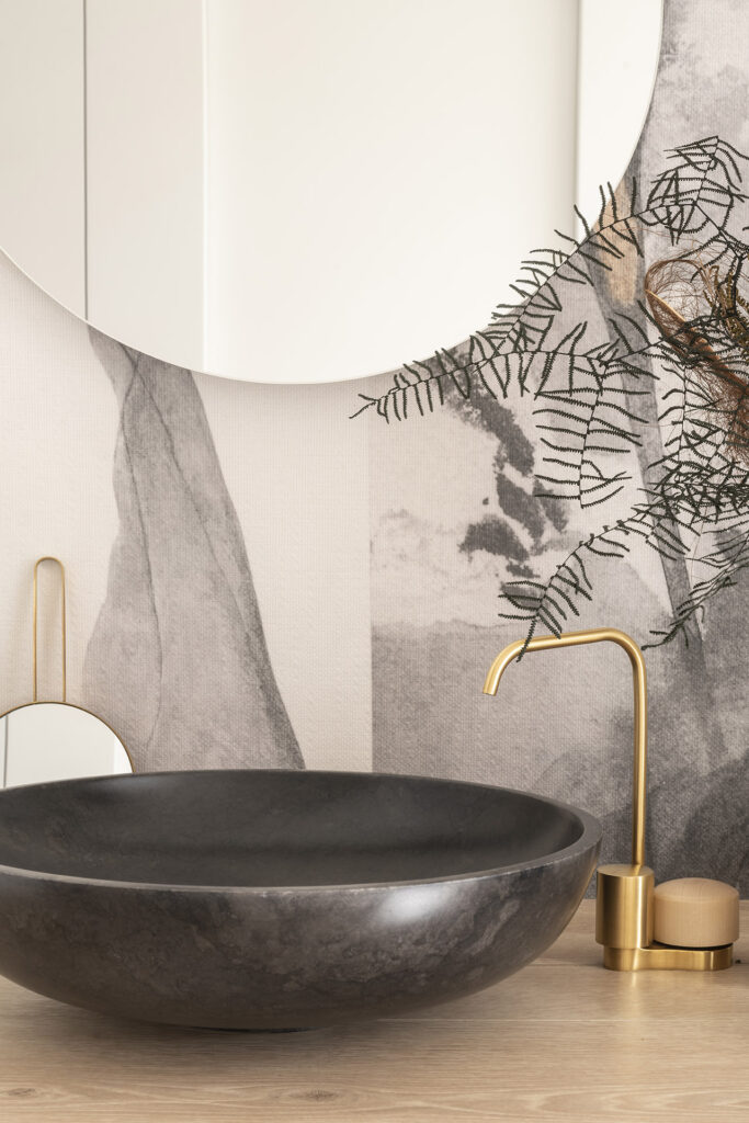 Citric House, featuring a black and gold sink and mirror, by Susanna Cots Interior Design.