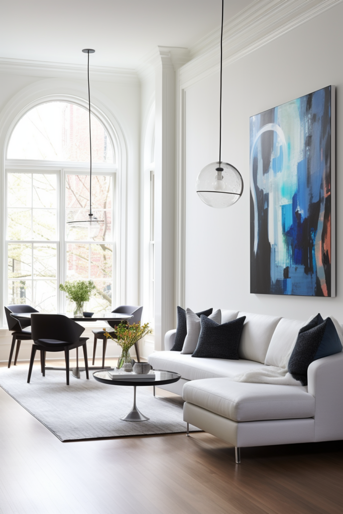 A white living room with a large painting on the wall, featuring furniture placement for narrow living rooms.