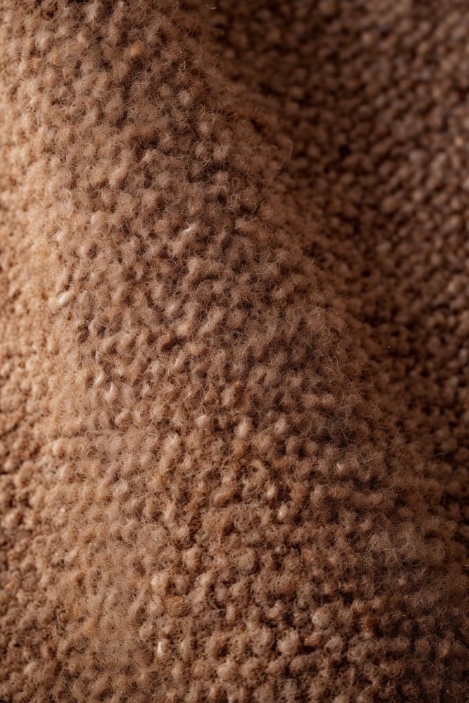 A close up image of a brown carpet, showcasing a potential interior design trend for 2024.