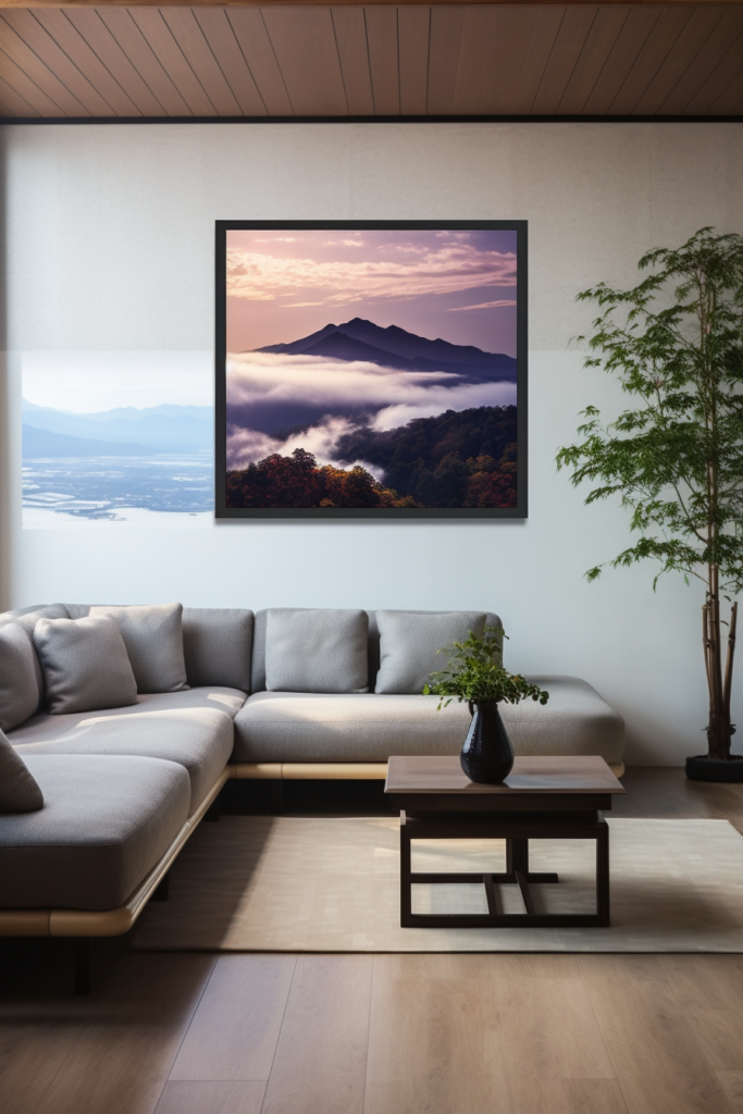 A large living room with Japanese wall art and a view of mountains and clouds.