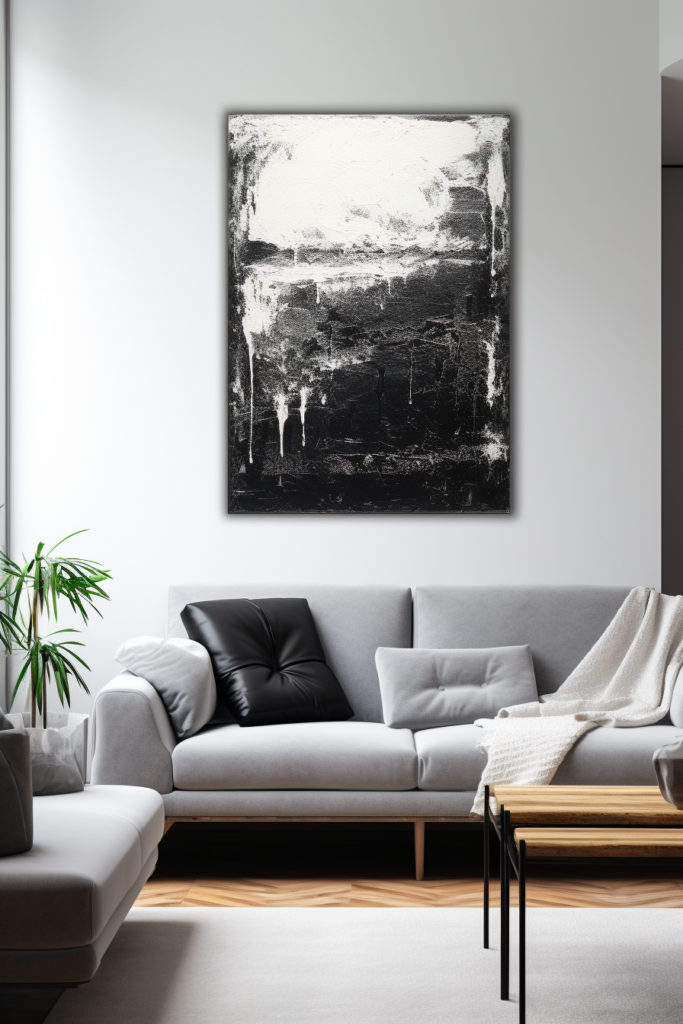 A large black and white painting hangs above a couch in a living room.