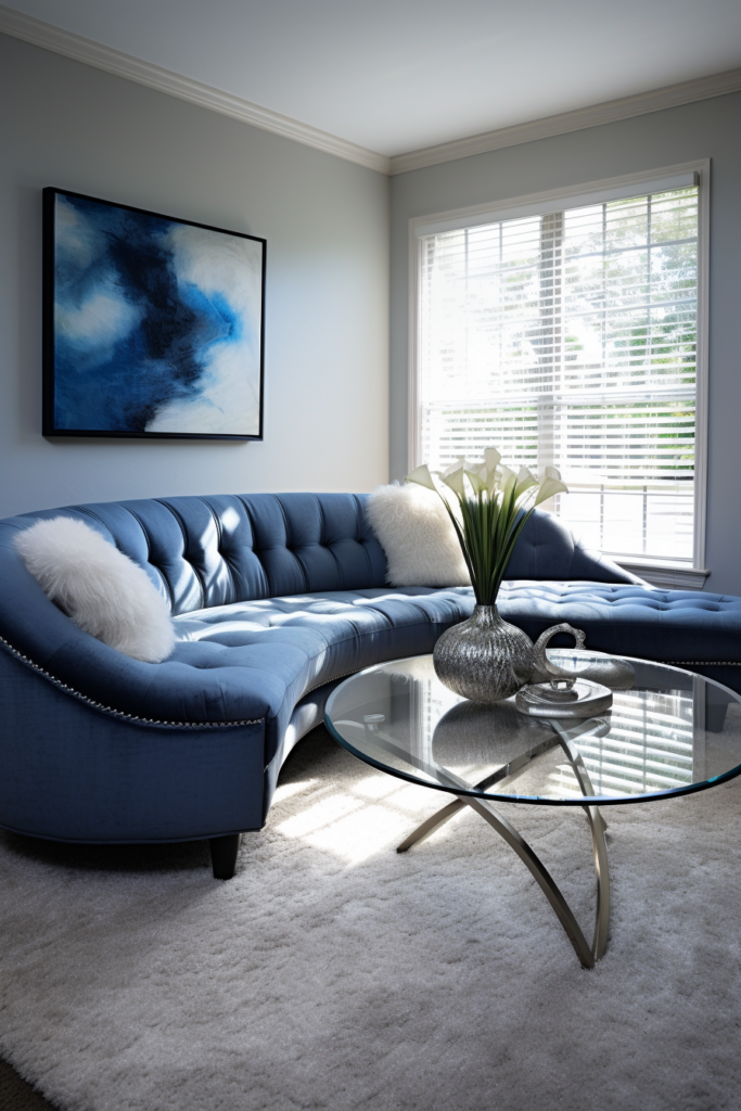 Cozy living room with a blue couch and a glass coffee table.